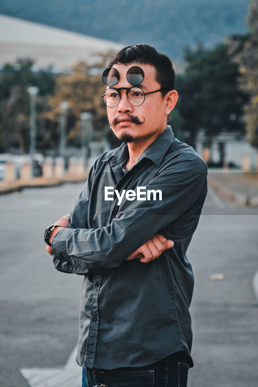 Man wearing eyewear while standing in city