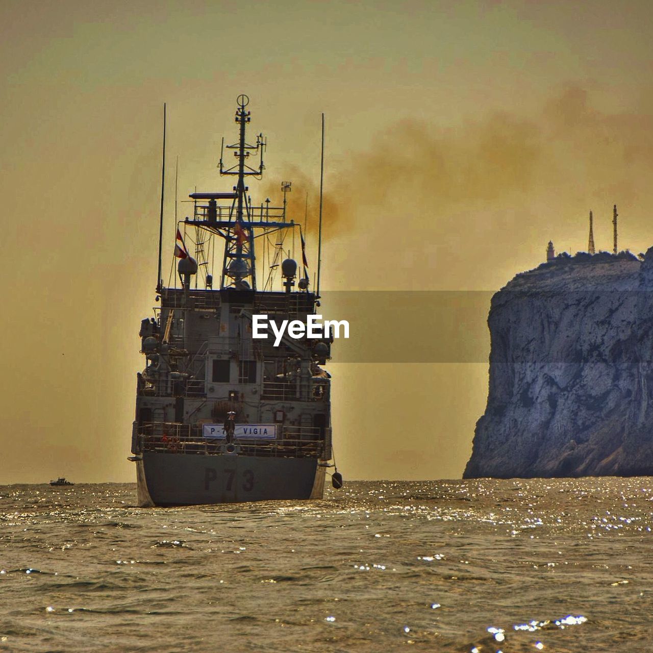 BOATS IN SEA AT SUNSET