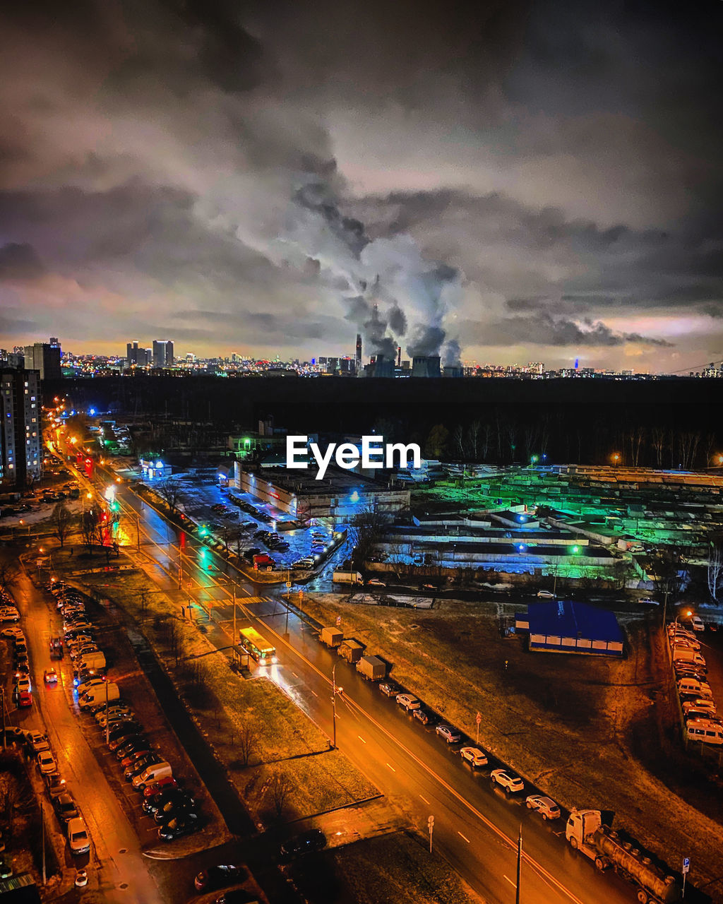 High angle view of illuminated cityscape against sky at night