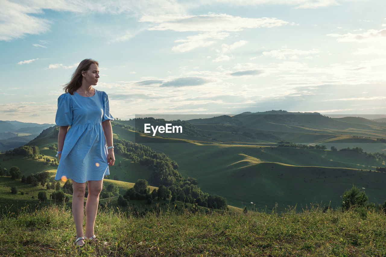 Woman standing outdoors against sky