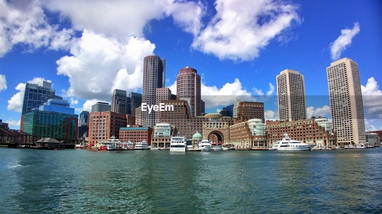 View of buildings in city against cloudy sky