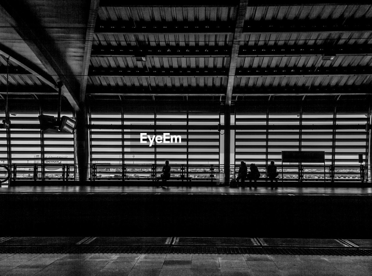 People walking on railroad station platform