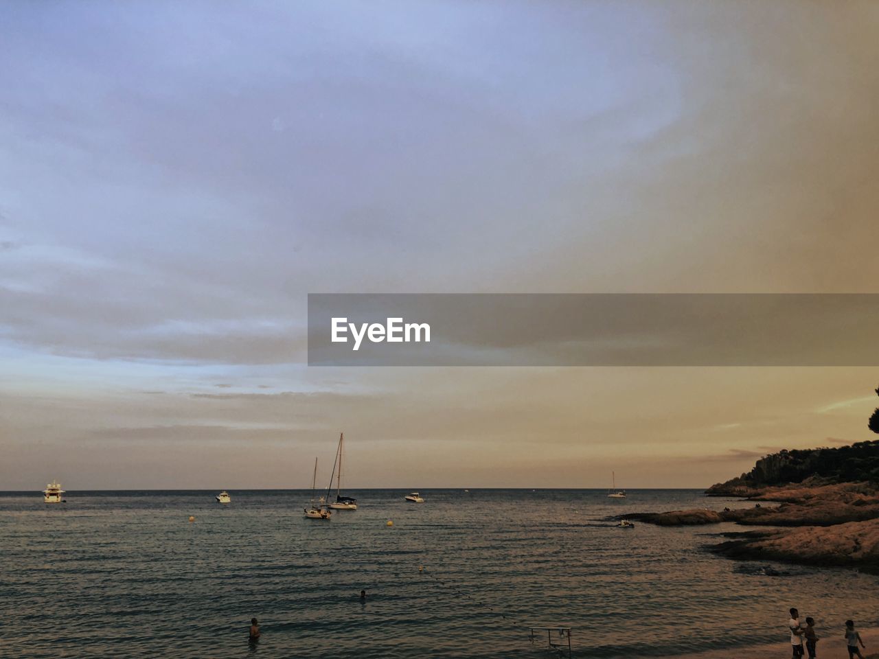 Scenic view of sea against sky at dusk