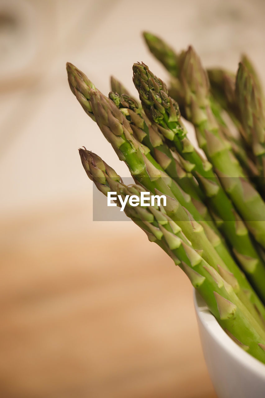 Close-up of green asparagus on table