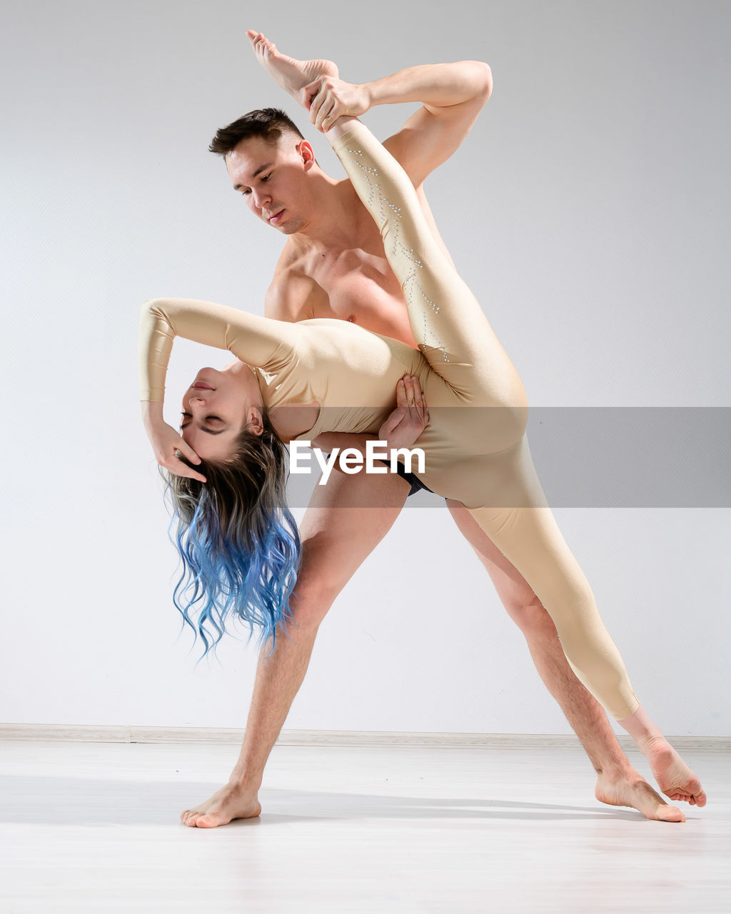 Full length of couple dancing against white background