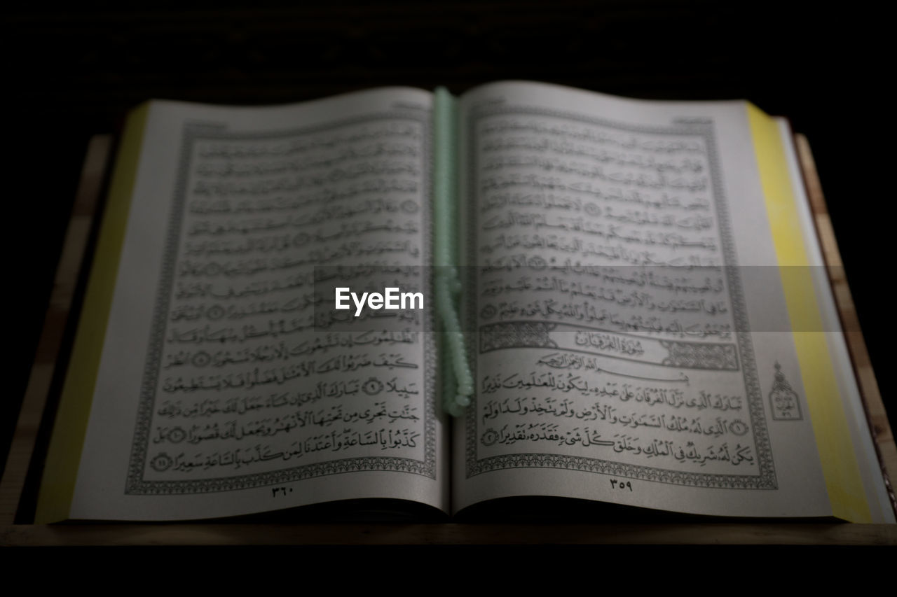 HIGH ANGLE VIEW OF BOOK ON TABLE