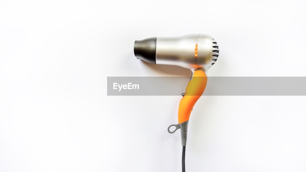 High angle view of hair dryer over white background