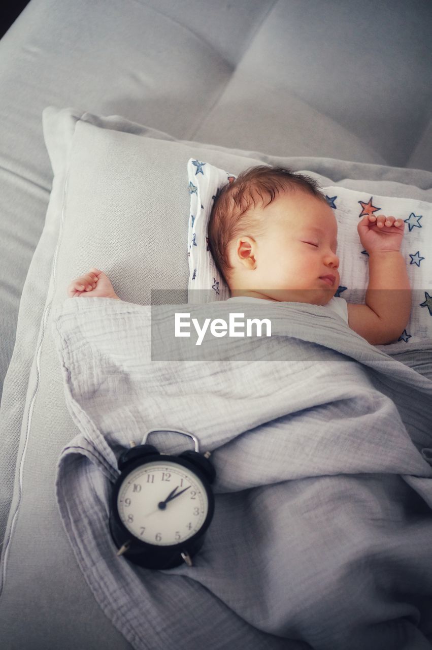 High angle view of baby boy sleeping on bed