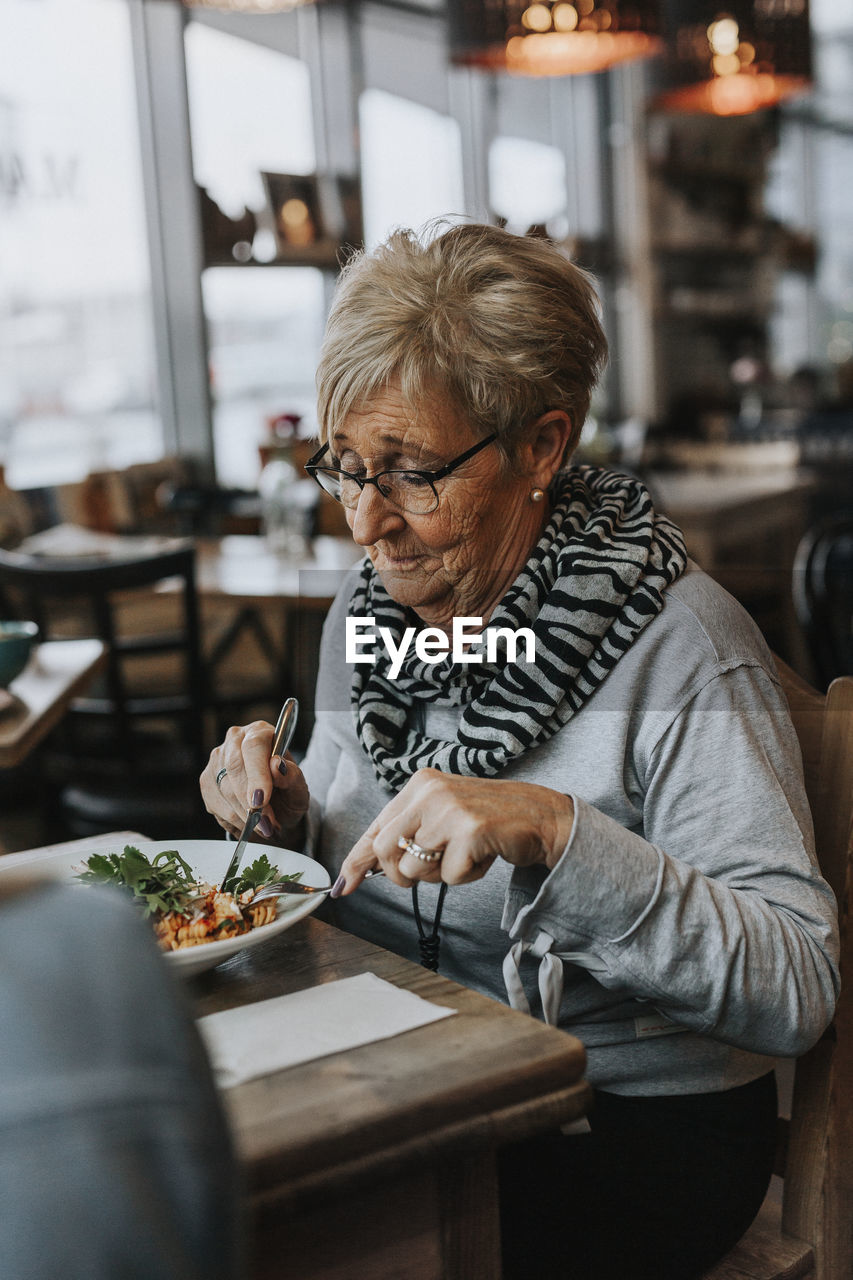 Woman having meal in cafe