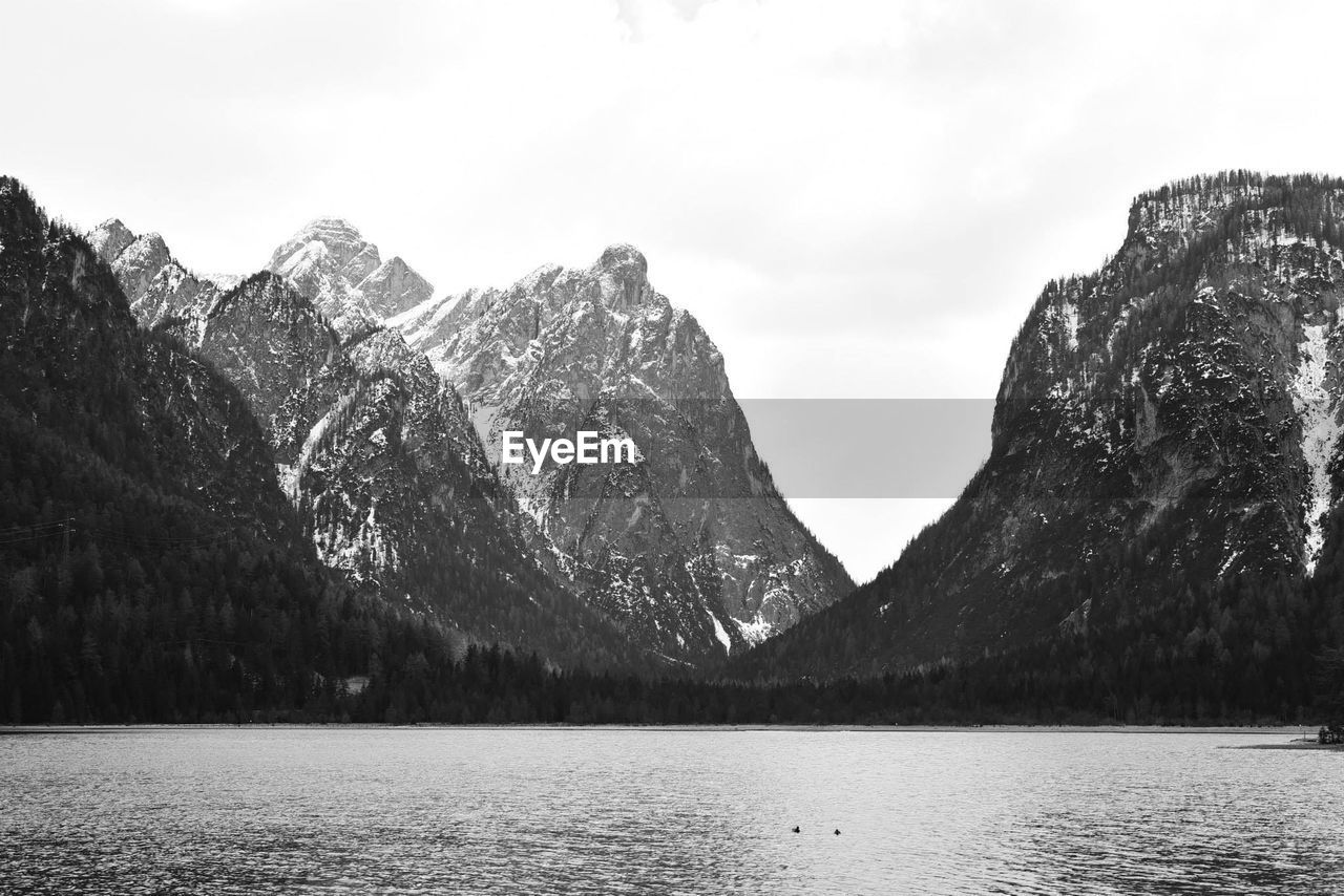 Scenic view of lake and mountains against sky