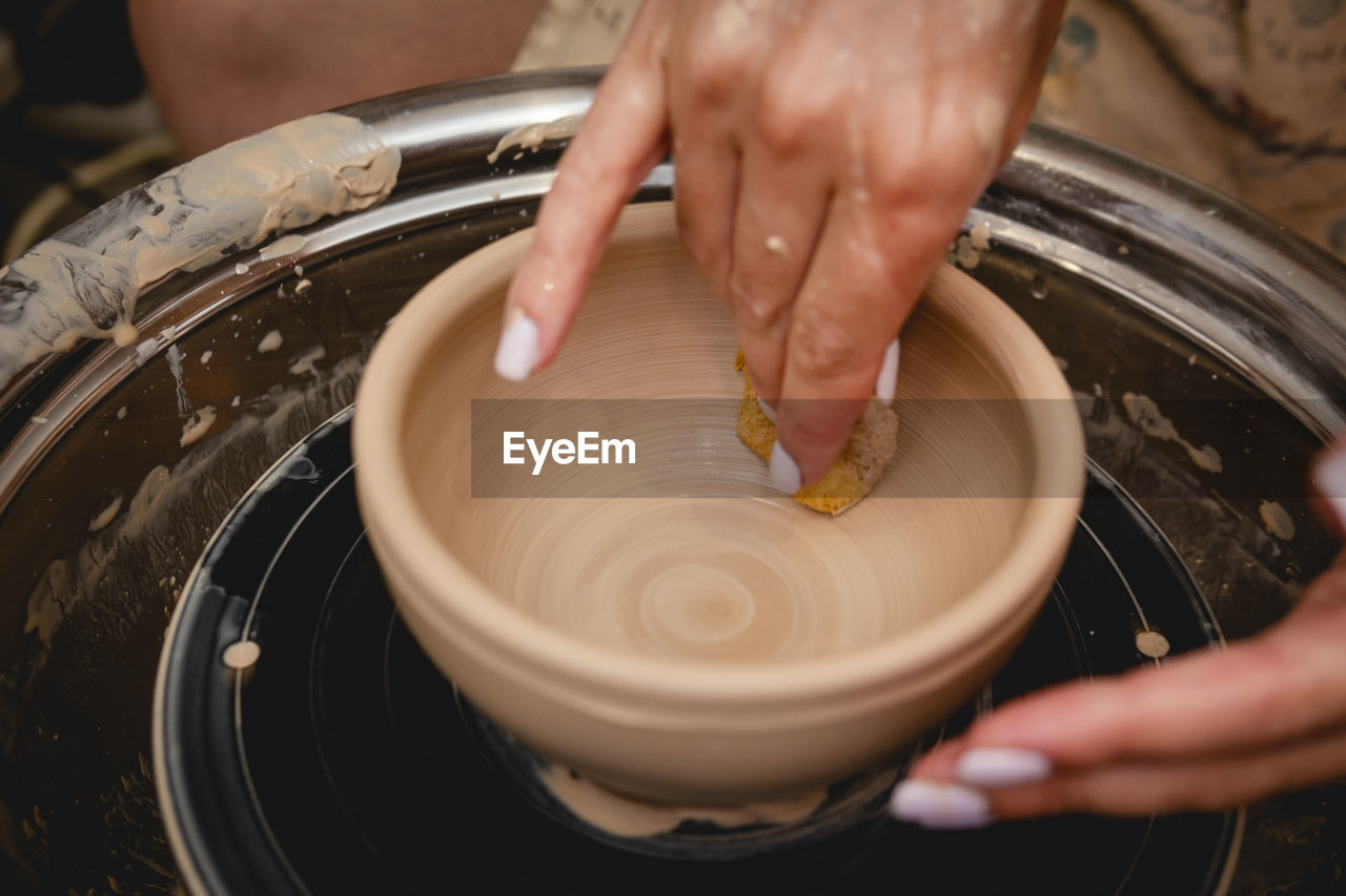 HIGH ANGLE VIEW OF PERSON PREPARING FOOD