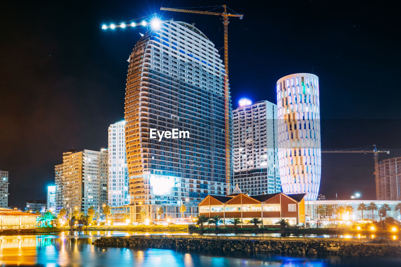 Reflection of illuminated buildings in city at night