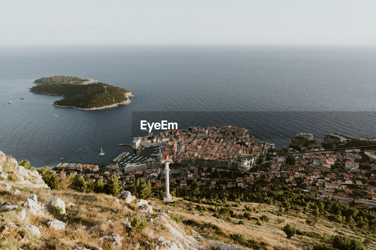 High angle view of sea and buildings against sky