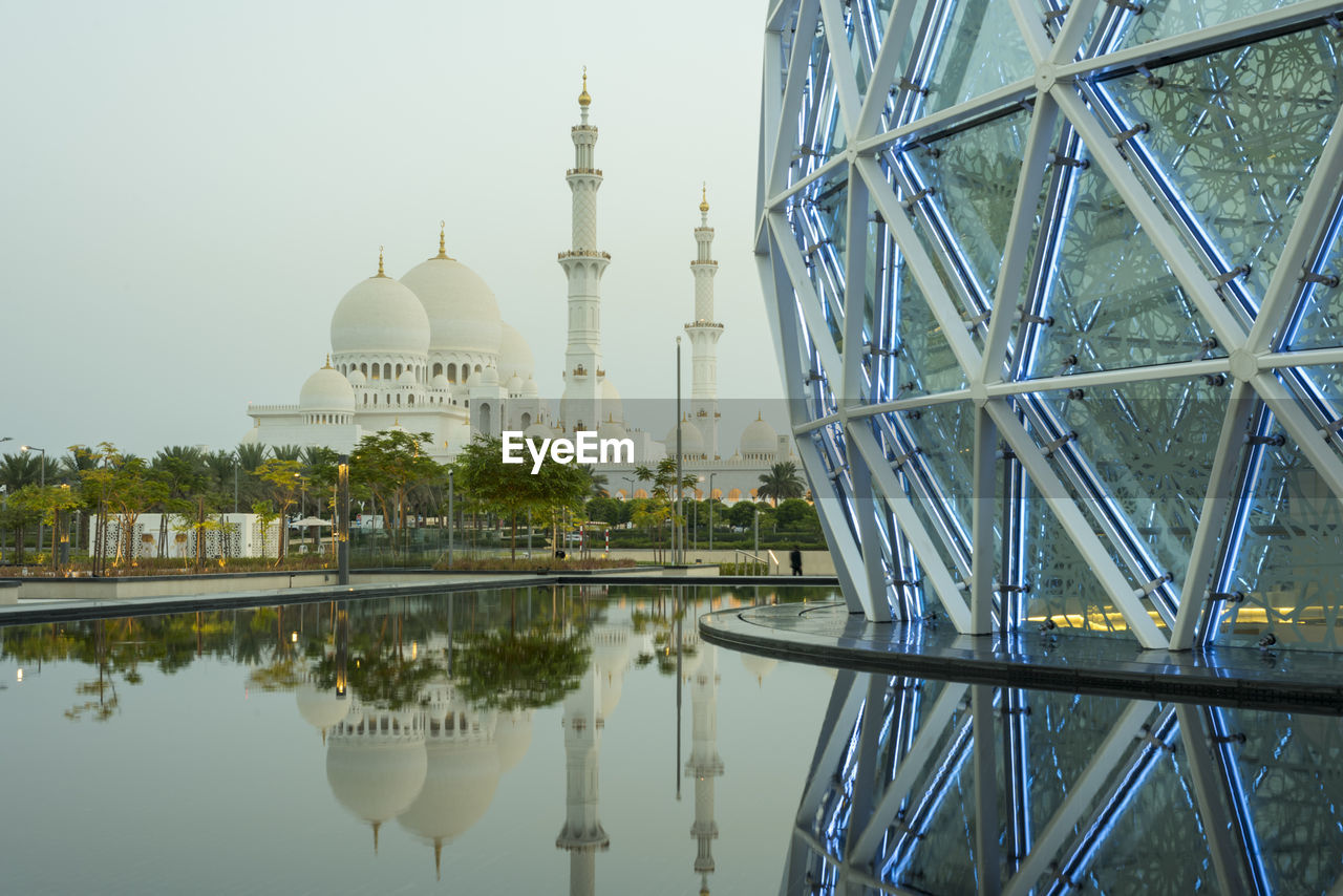 architecture, built structure, reflection, dome, water, building exterior, travel destinations, religion, landmark, place of worship, belief, sky, nature, travel, tourism, building, spirituality, city, lake, no people, outdoors, tower, plant, tree, day, history, clear sky