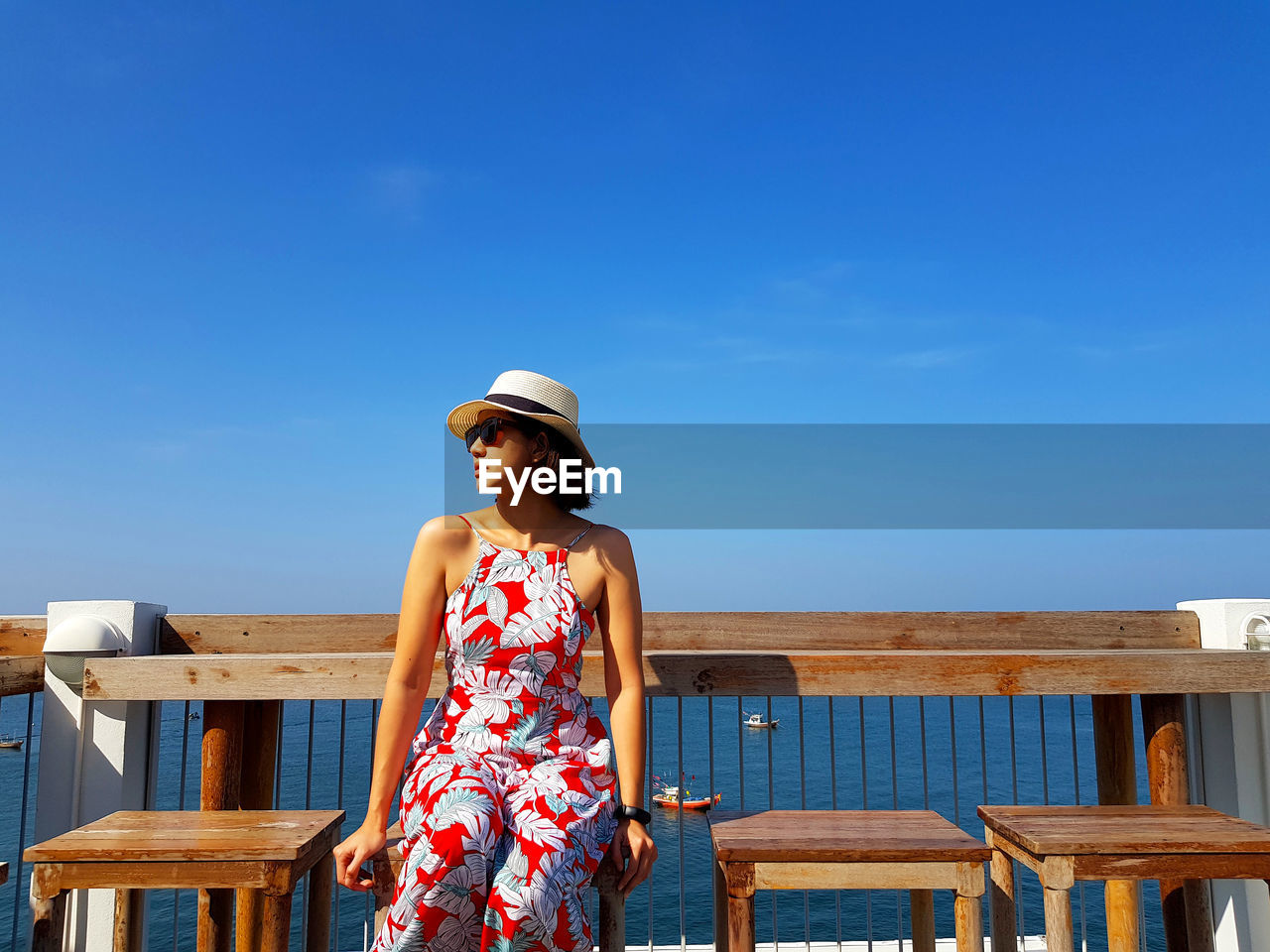 Beautiful woman looking away against sky