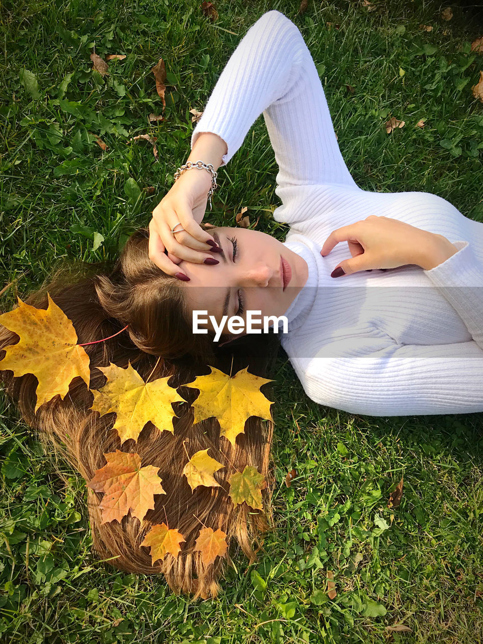 Low section of young woman lying on land