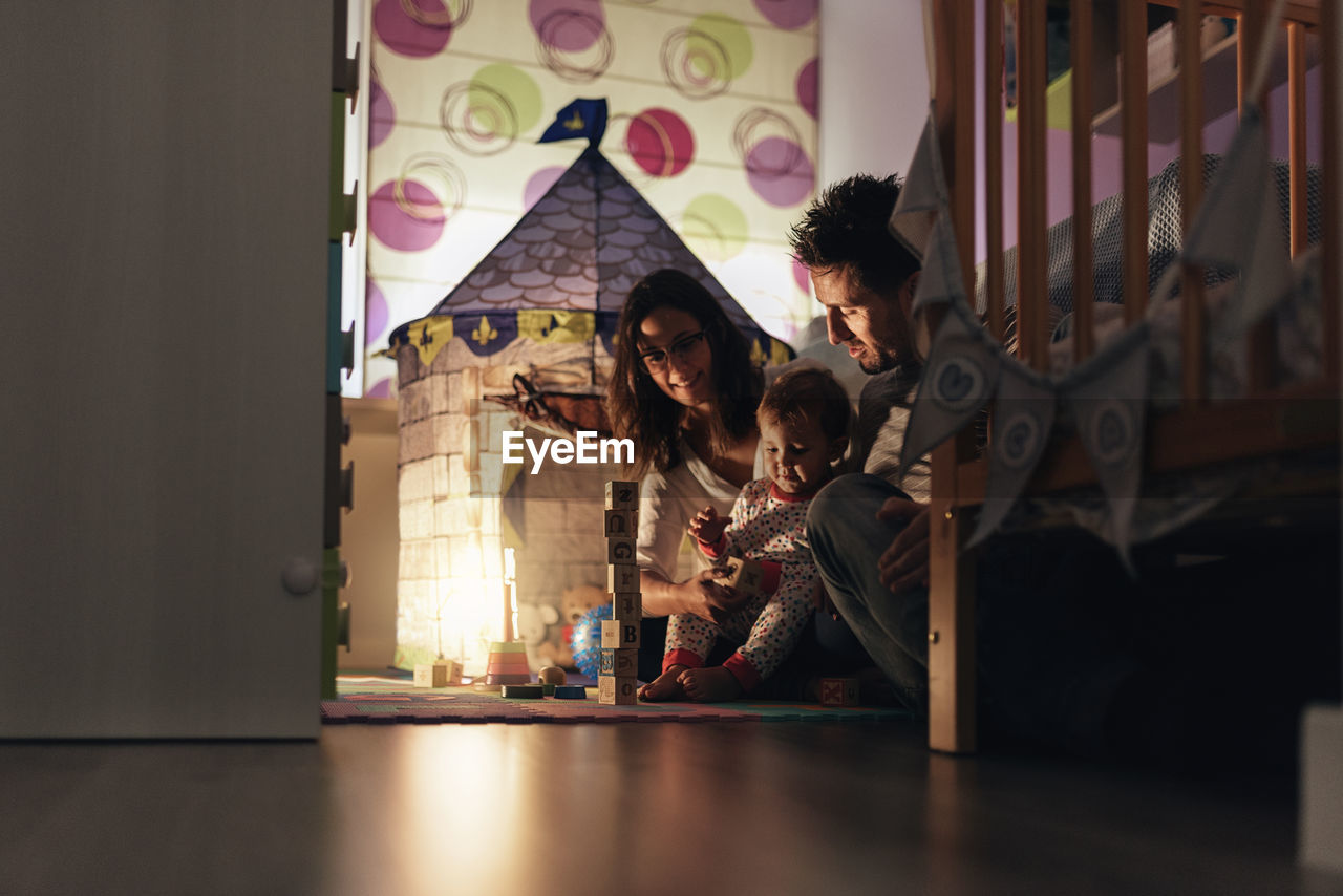 Parents playing with boy at home