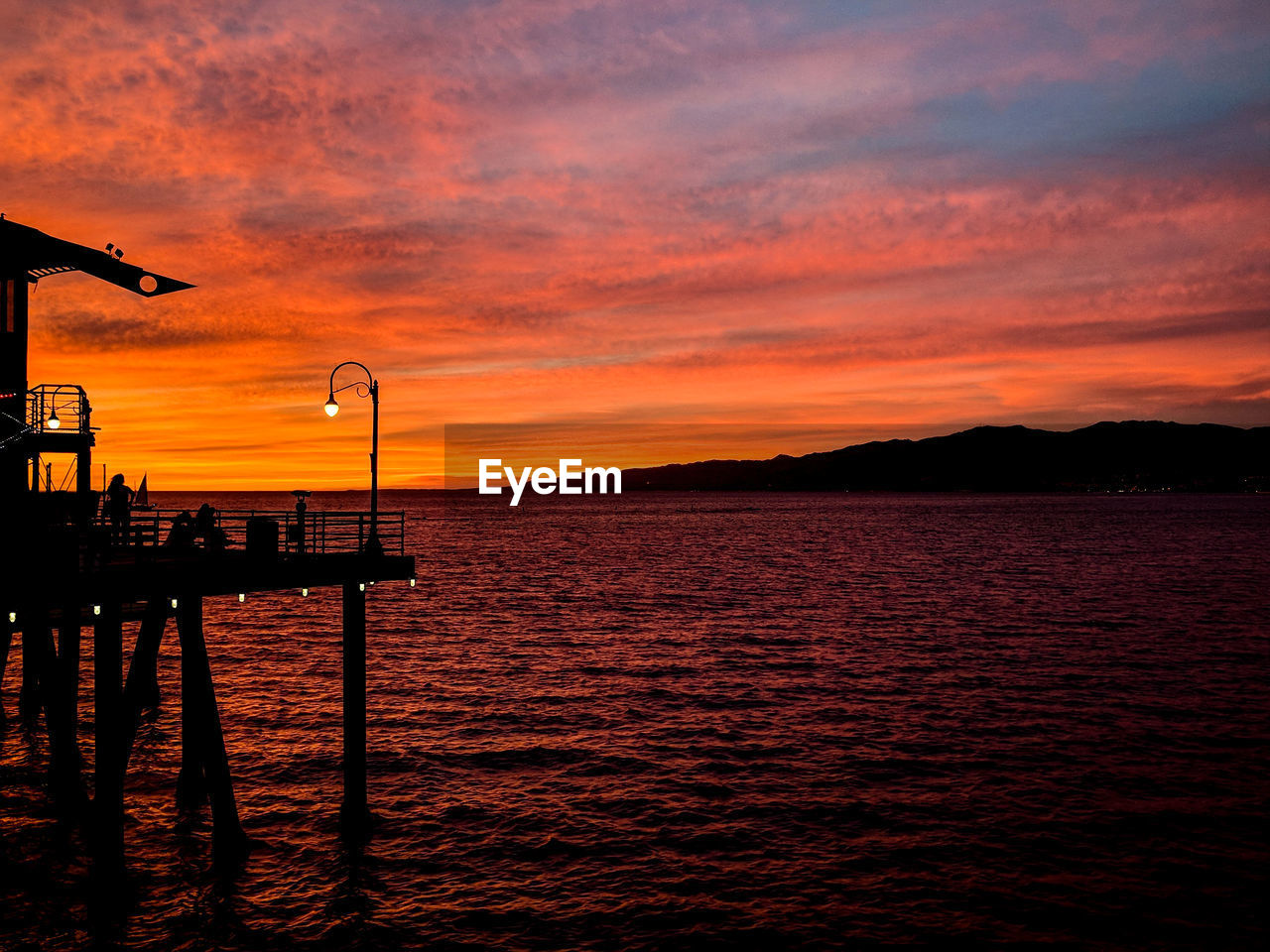 Scenic view of sea against orange sky