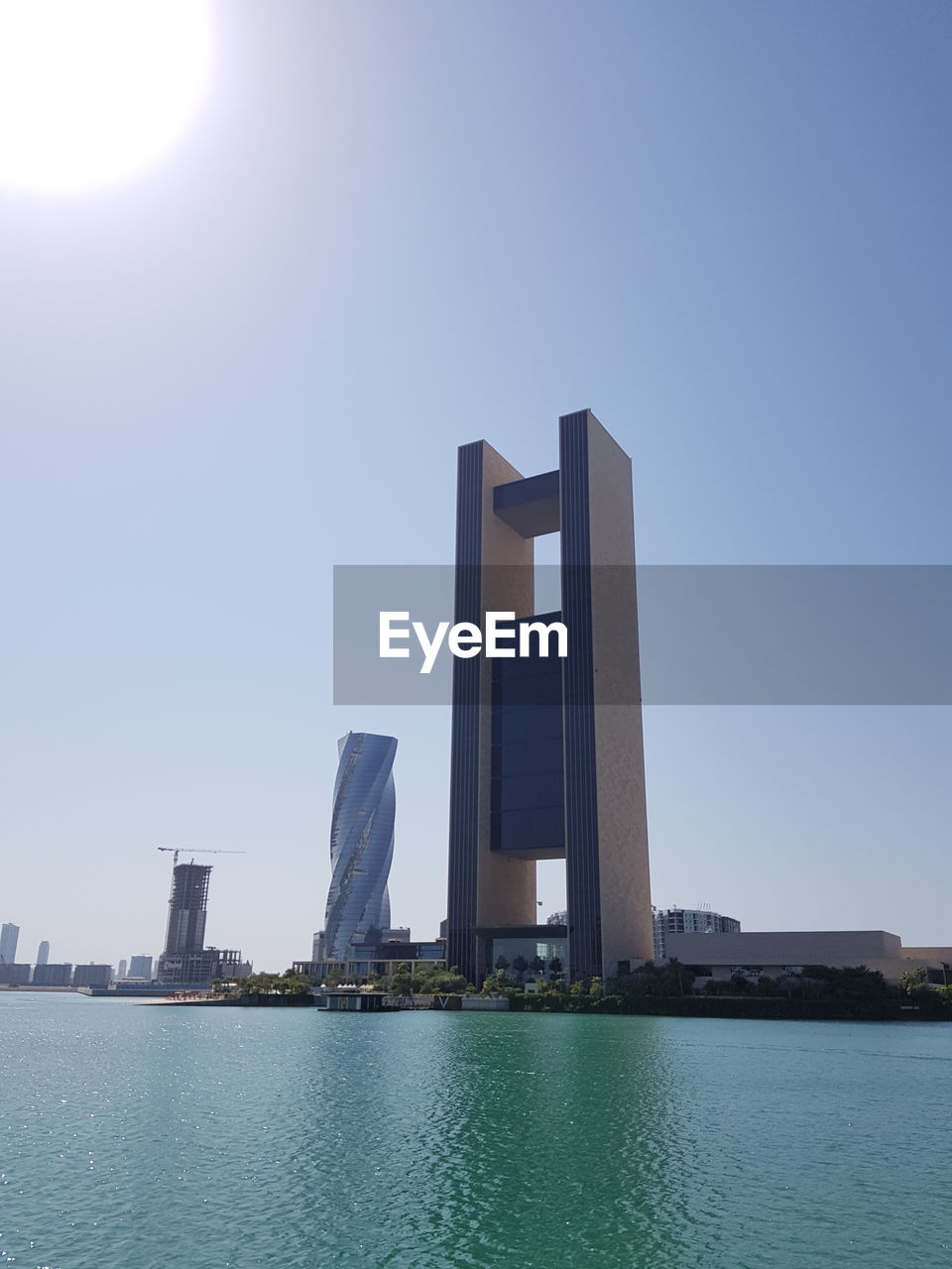 MODERN BUILDINGS AGAINST SKY IN CITY AGAINST CLEAR BLUE BACKGROUND