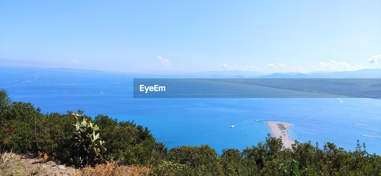 water, sky, scenics - nature, sea, environment, beauty in nature, nature, mountain, landscape, plant, land, tree, blue, tranquility, travel, travel destinations, tranquil scene, no people, cloud, outdoors, beach, tourism, mountain range, day, non-urban scene, horizon, wilderness, ridge, coast, forest, idyllic, coastline, vacation, horizon over water, trip, social issues, panoramic, body of water, holiday, pinaceae