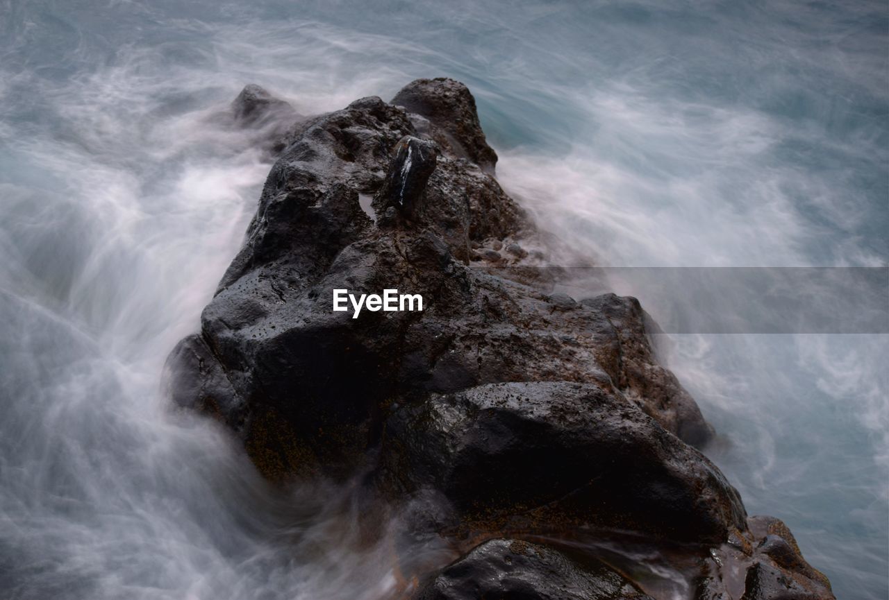 Scenic view of waves on rocks