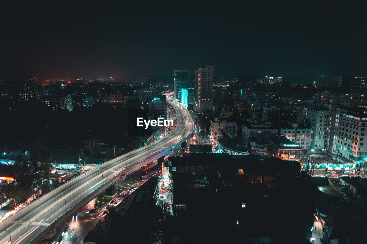 High angle view of illuminated city buildings at night