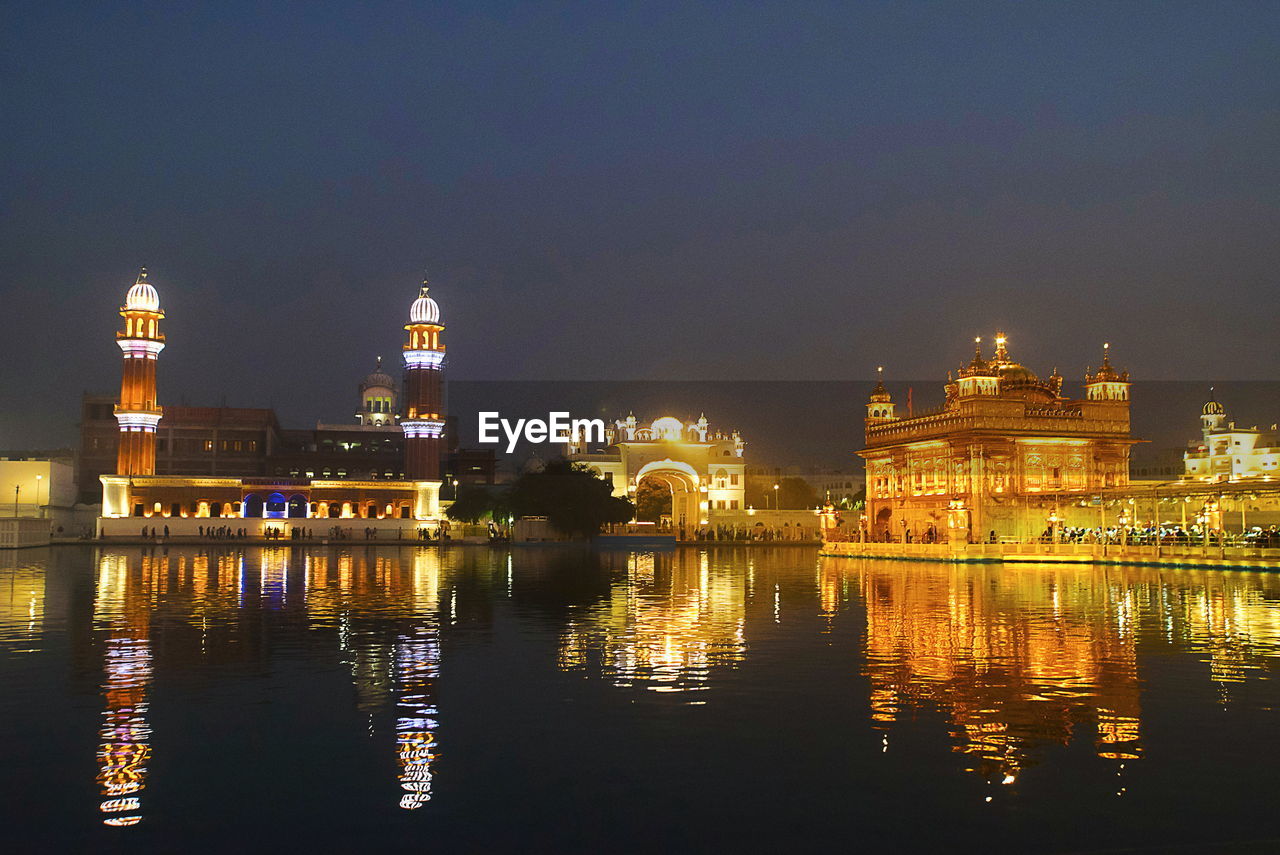 ILLUMINATED BUILDINGS AT WATERFRONT