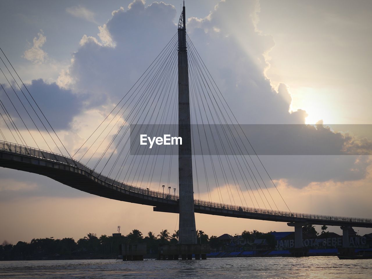 VIEW OF SUSPENSION BRIDGE OVER RIVER