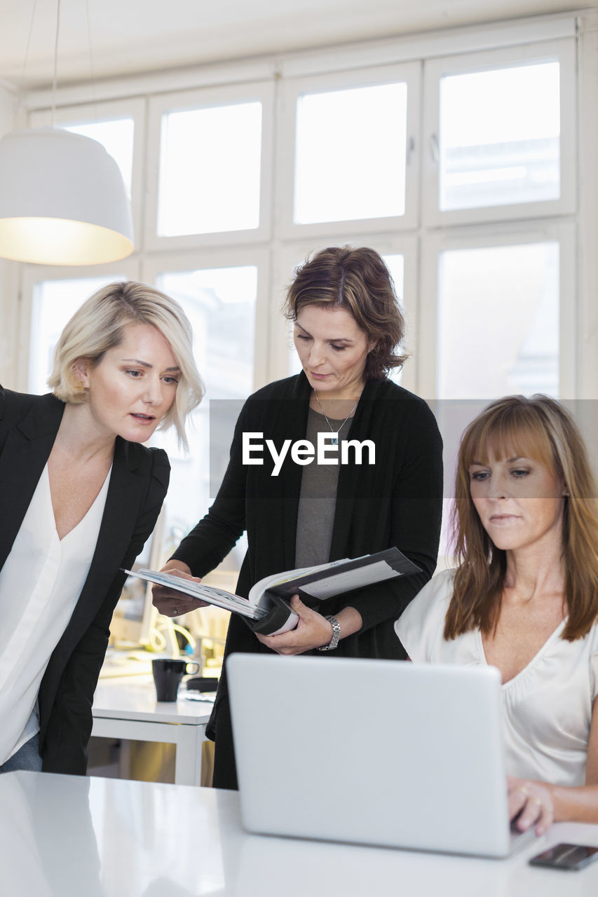 Businesswomen working on laptop in office