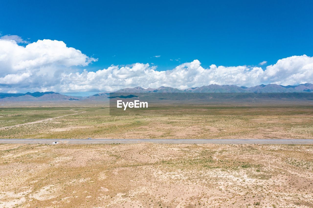 SCENIC VIEW OF FIELD AGAINST BLUE SKY