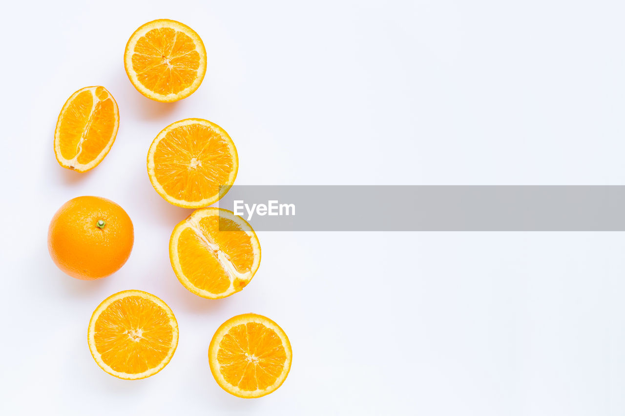 ORANGE FRUITS AGAINST WHITE BACKGROUND