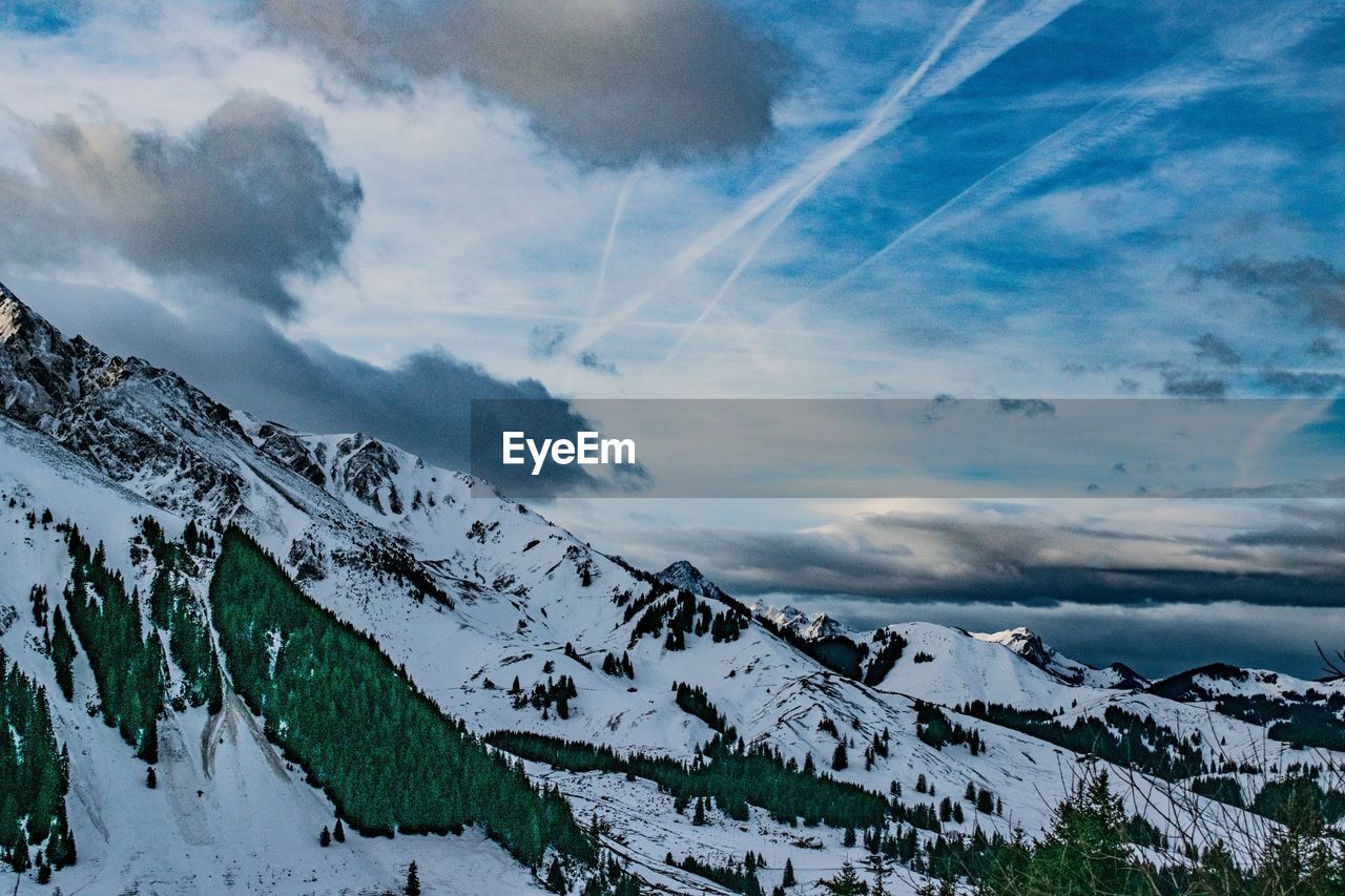 Scenic view of snowcapped mountains against sky