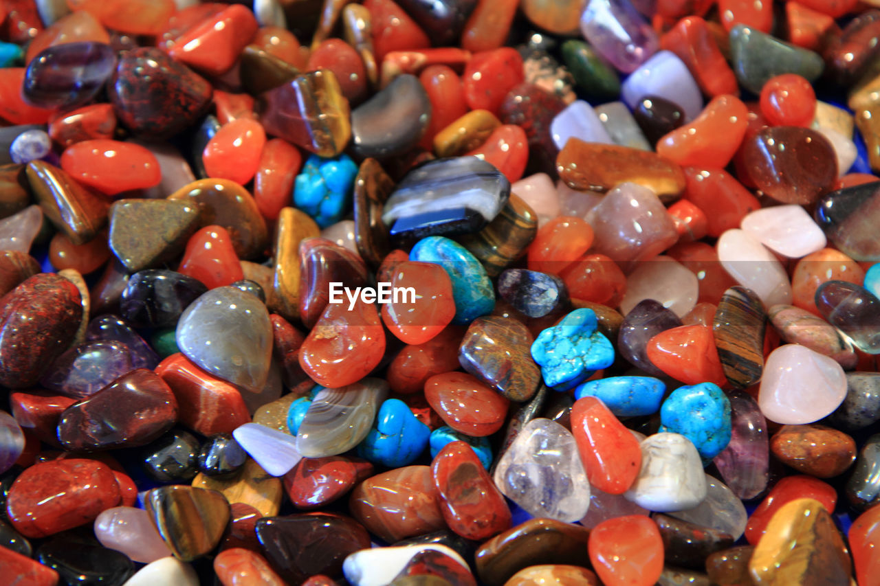 HIGH ANGLE VIEW OF MULTI COLORED PEBBLES IN CONTAINER