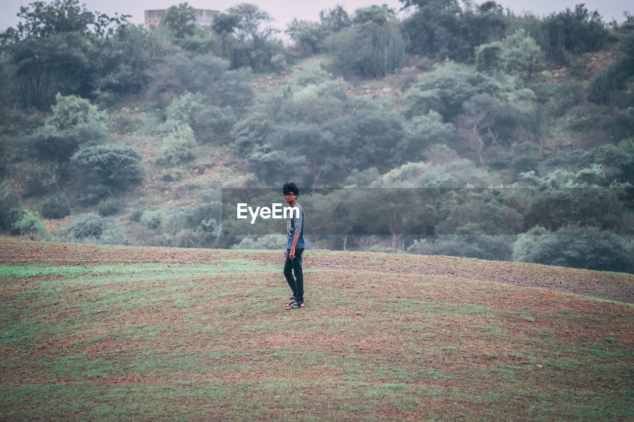 Portrait of man standing on field