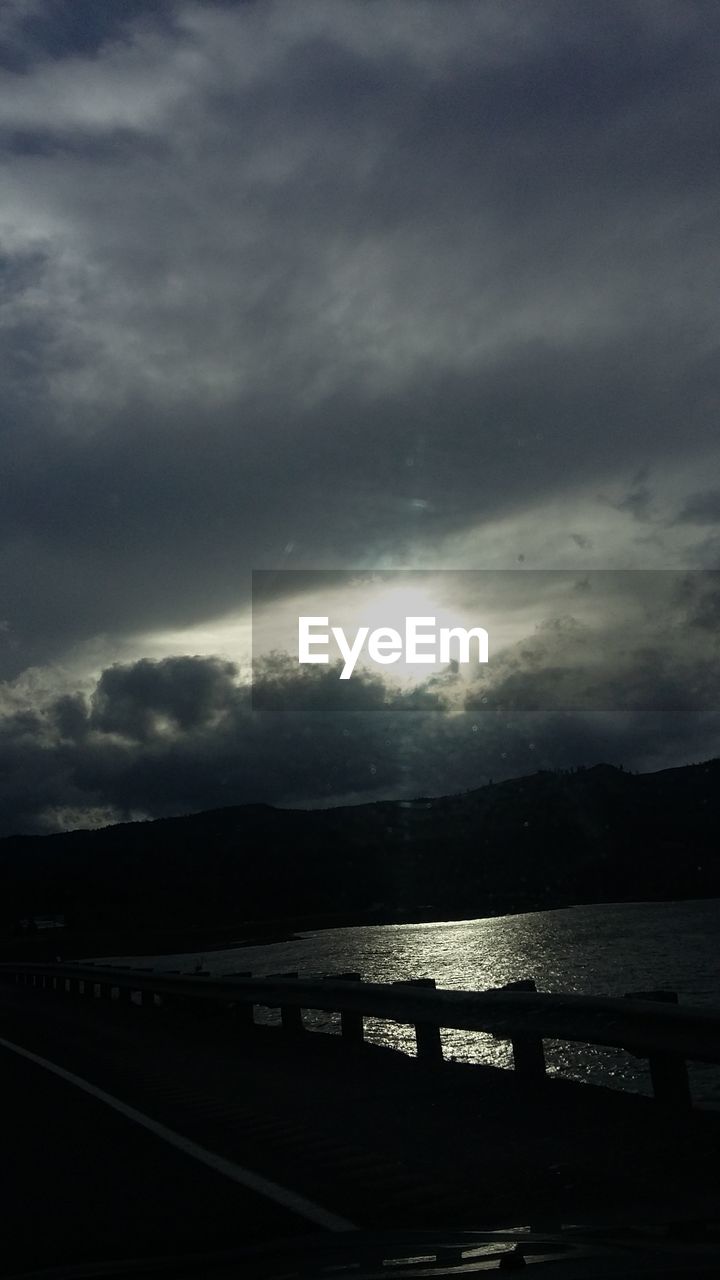 VIEW OF RIVER AGAINST CLOUDY SKY