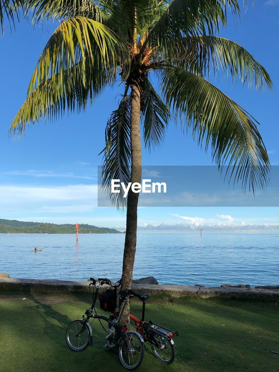 BICYCLE ON BEACH AGAINST SKY