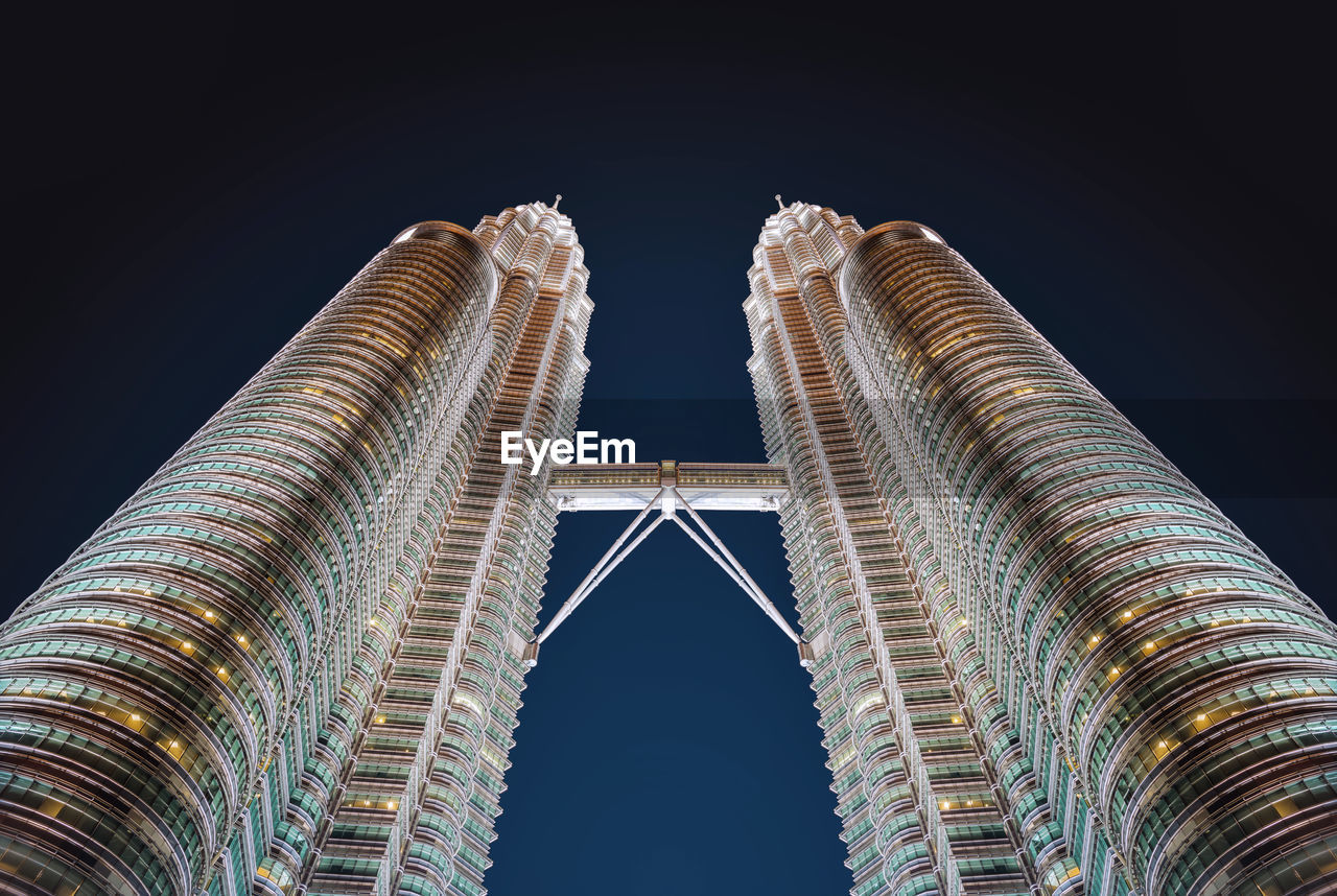 Low angle view of buildings against sky at night