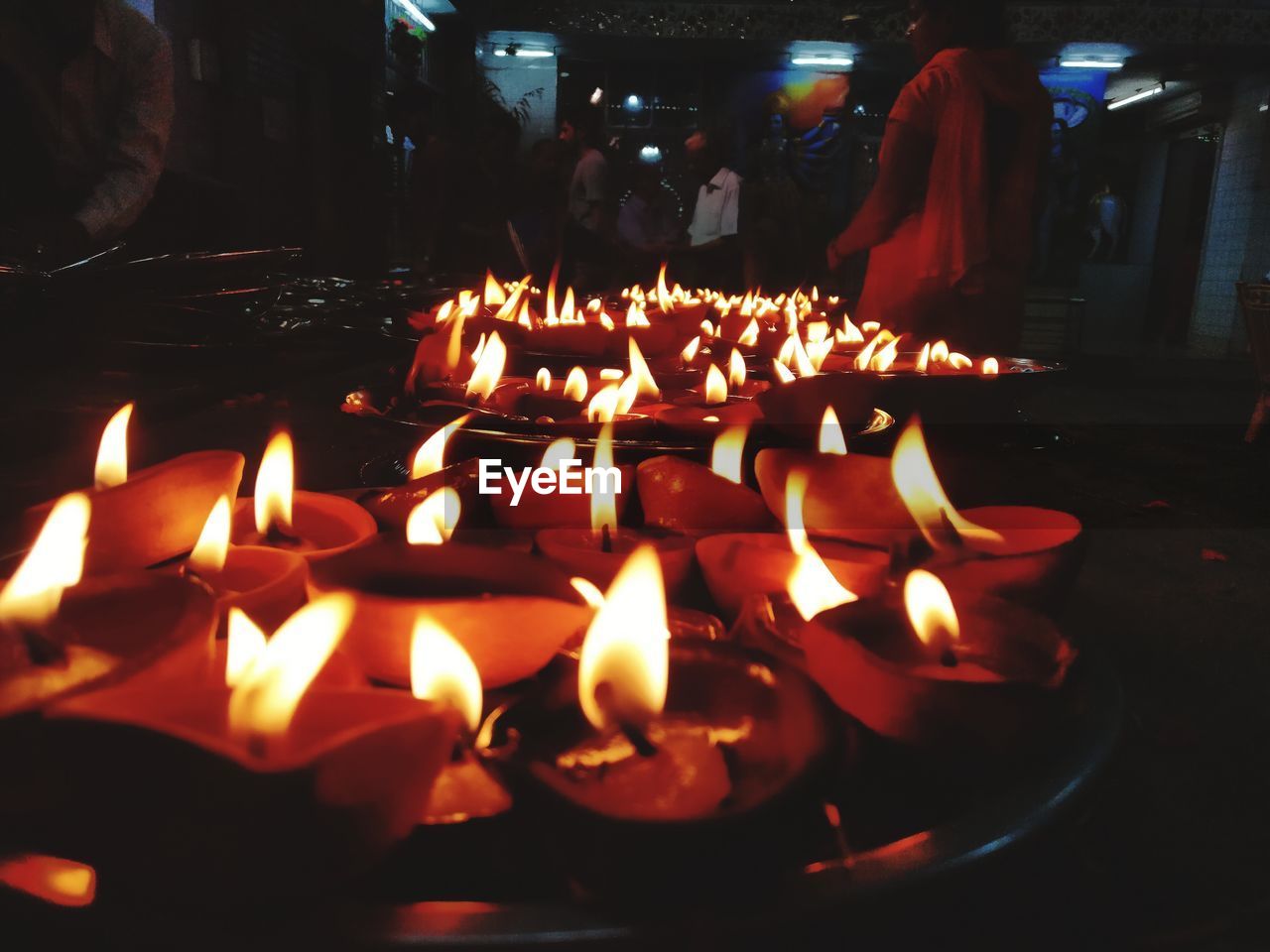 BURNING CANDLES IN ILLUMINATED TEMPLE