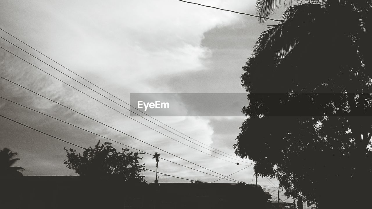 LOW ANGLE VIEW OF POWER LINES AGAINST CLOUDY SKY