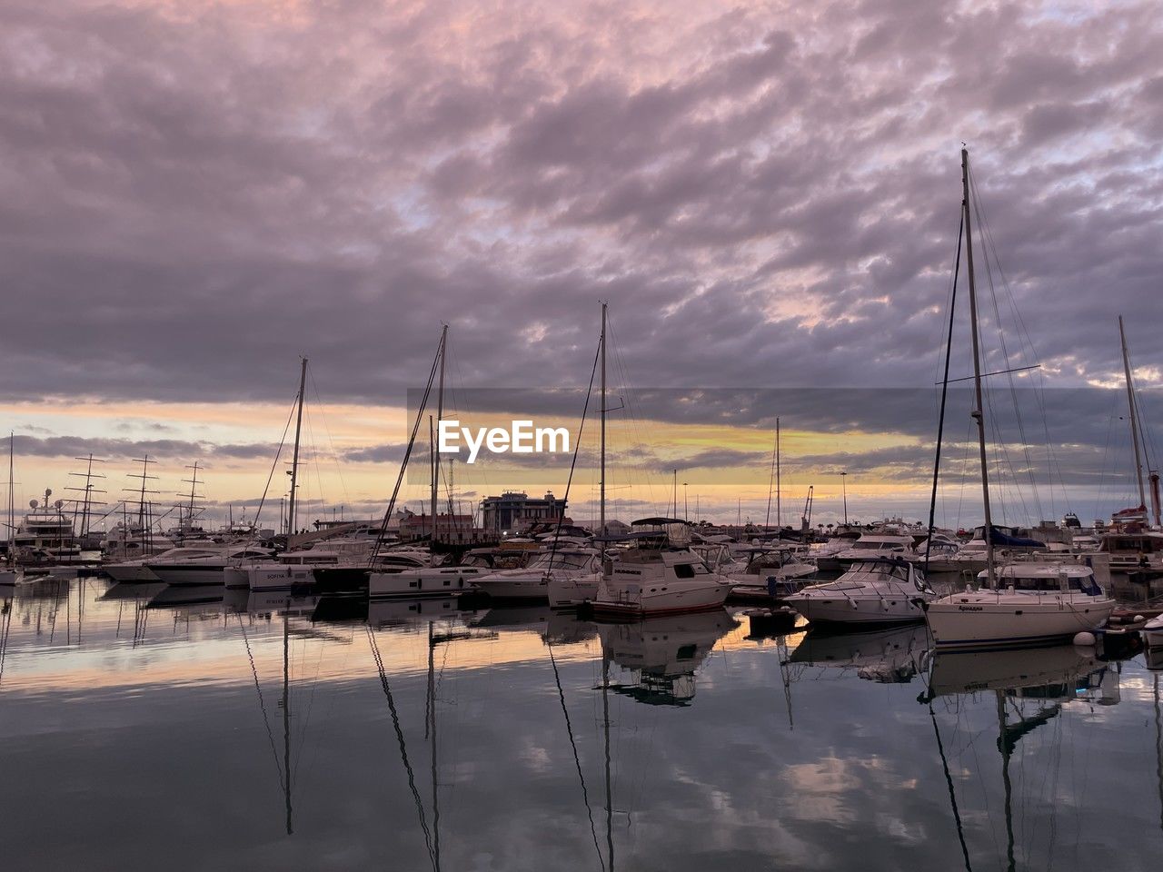 water, nautical vessel, sky, cloud, transportation, sailboat, marina, dock, mode of transportation, reflection, mast, pole, sea, sunset, nature, harbor, moored, ship, vehicle, boat, beauty in nature, no people, dramatic sky, tranquility, dusk, scenics - nature, evening, tranquil scene, travel, moody sky, sailing, idyllic, outdoors, yacht, travel destinations, watercraft, twilight, architecture