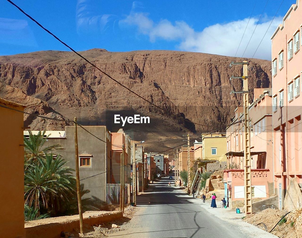 Street amidst buildings against mountain