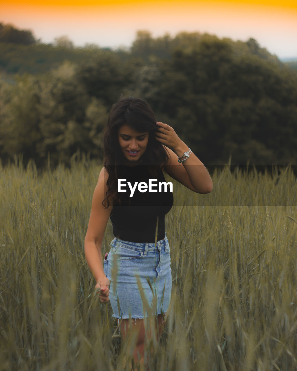 HAPPY WOMAN STANDING ON FIELD