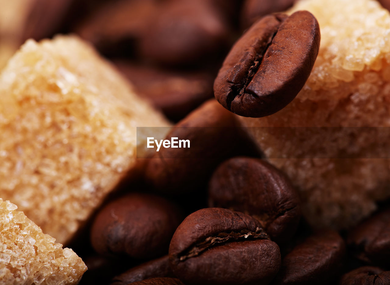 Detail shot of sugar cubes on coffee beans