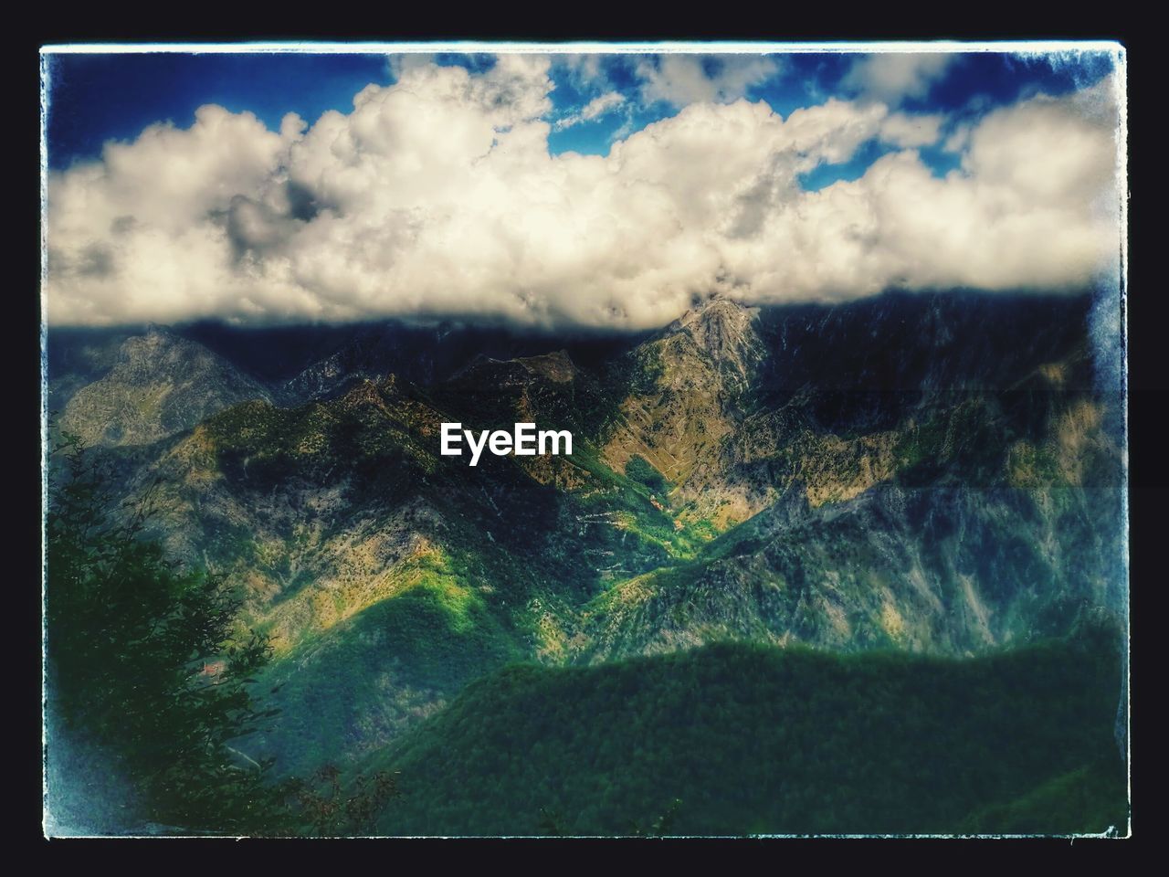 SCENIC VIEW OF MOUNTAIN AGAINST CLOUDY SKY