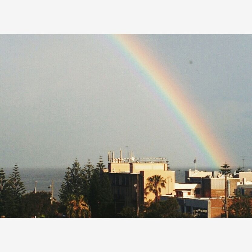 VIEW OF RAINBOW OVER BUILDINGS