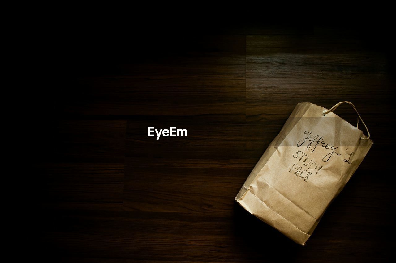 High angle view of paper bag on wooden table