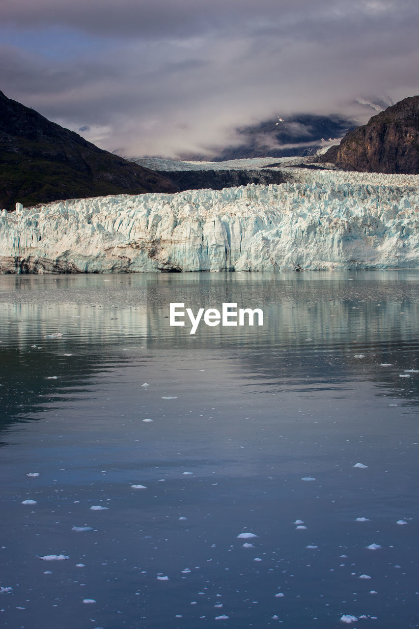 Scenic view of lake against mountain during winter