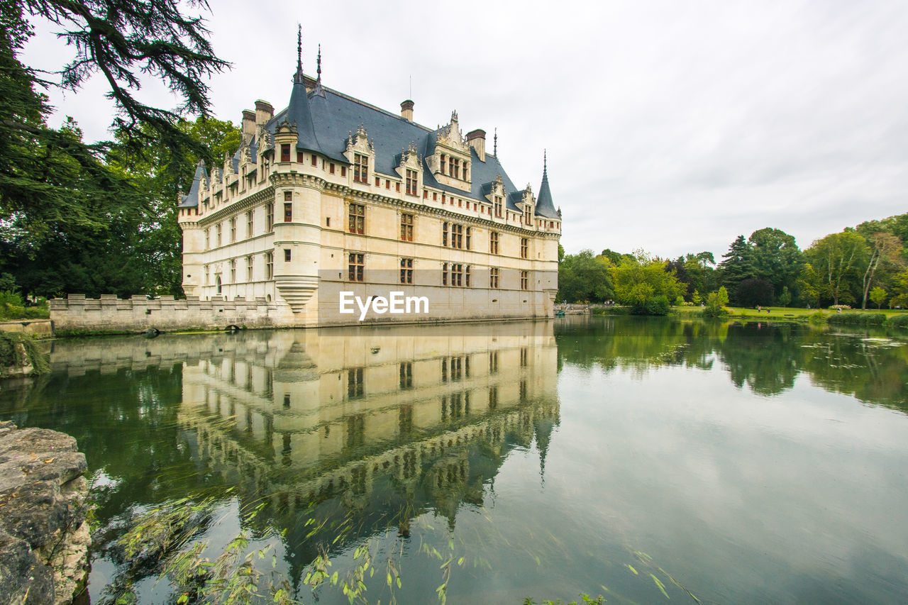 REFLECTION OF BUILDING IN LAKE WATER