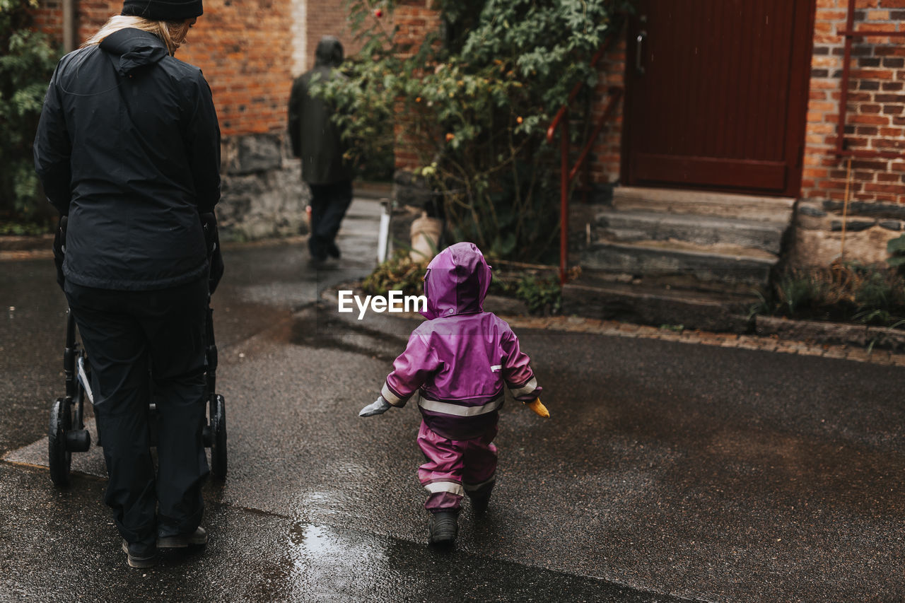 Mother walking with toddler girl