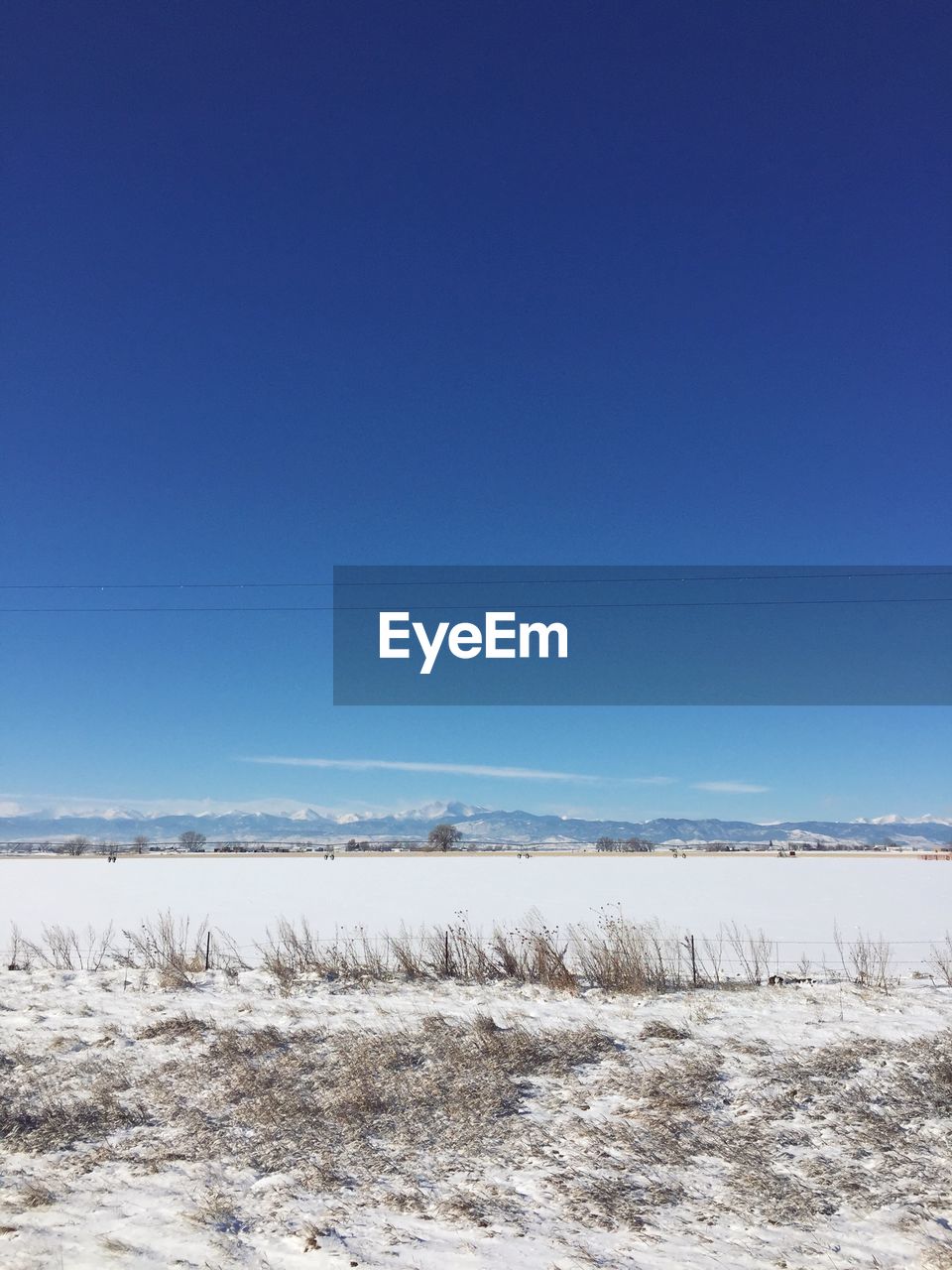 SNOW LANDSCAPE AGAINST CLEAR BLUE SKY